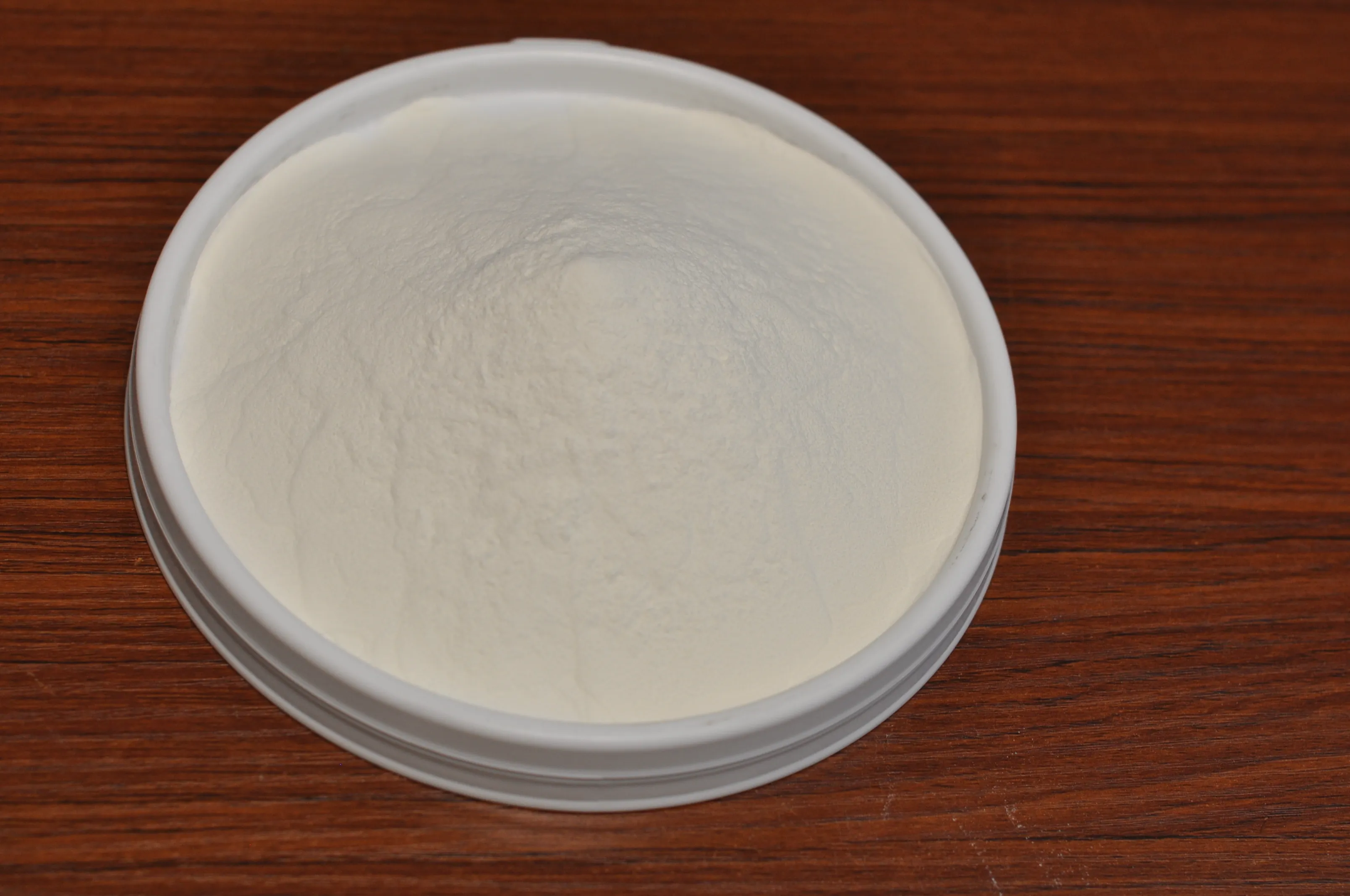 Laboratory sample of PC-306 PCE powder superplasticizer showing fine white powder consistency and quality appearance.