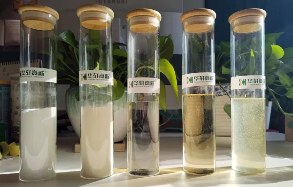 Laboratory test tubes containing different types of polycarboxylate superplasticizer liquid and powder samples for concrete admixture formulation testing.